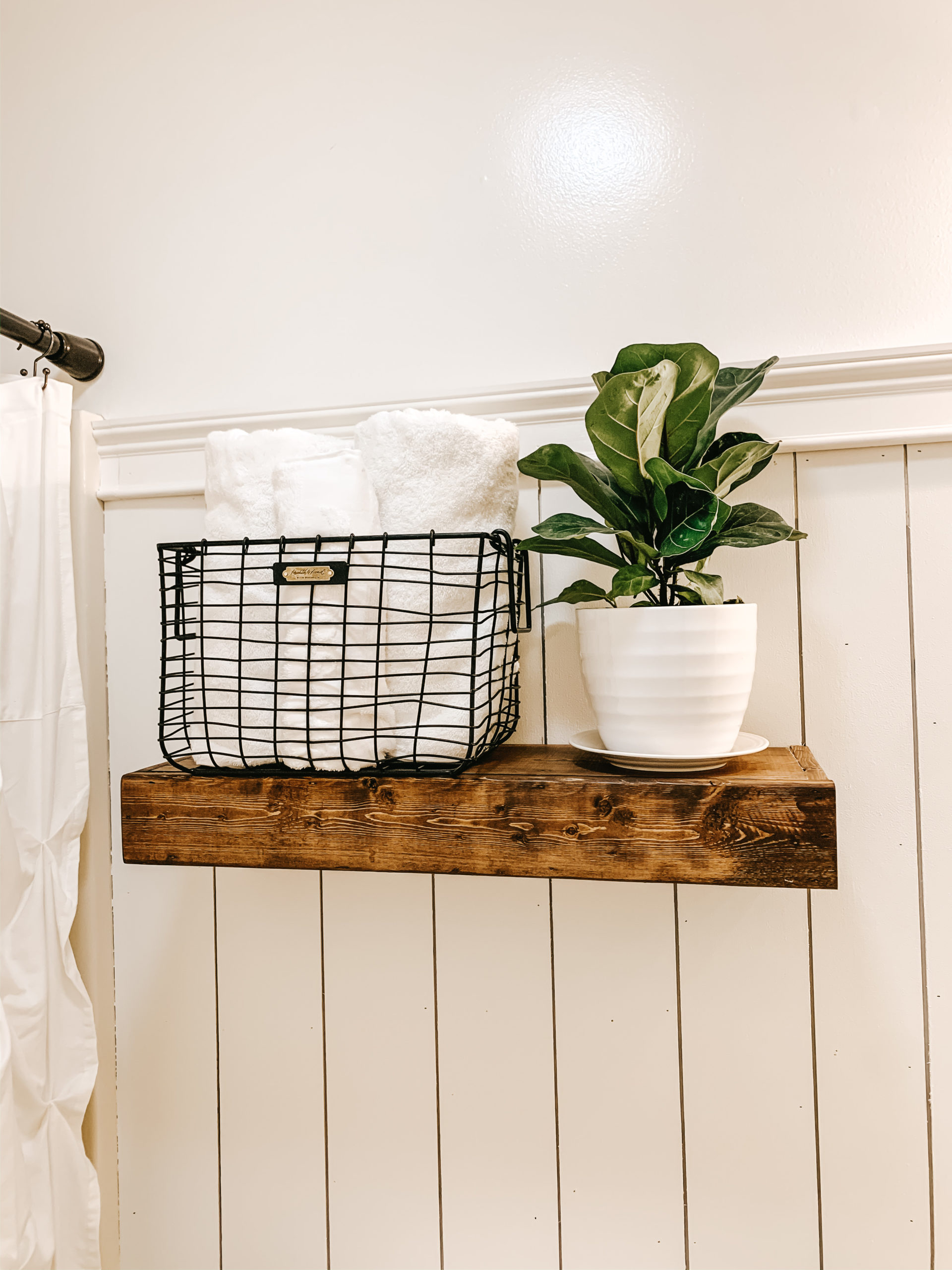 DIY Floating Shelf work great for small spaces - over bathroom toilets filled with towels and plants